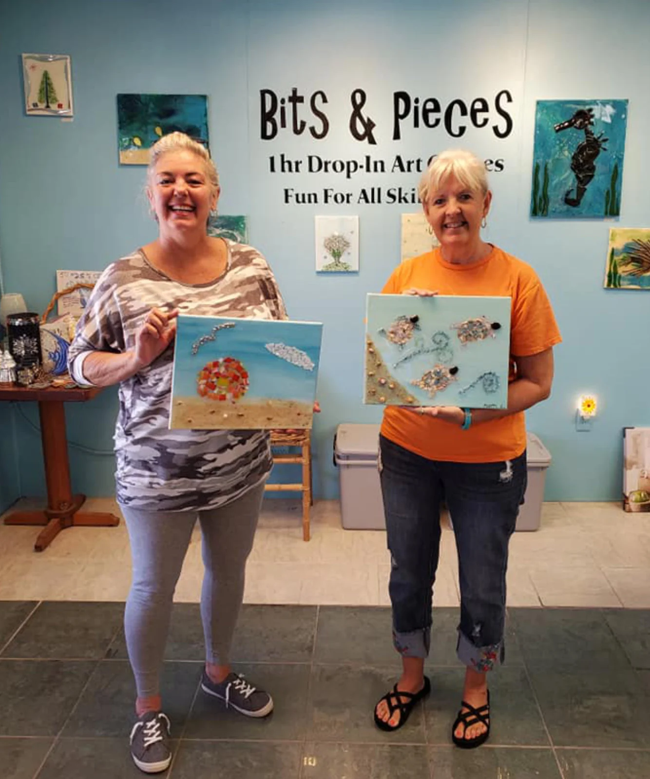 Ladies showing off their work at Art of Glass SGI