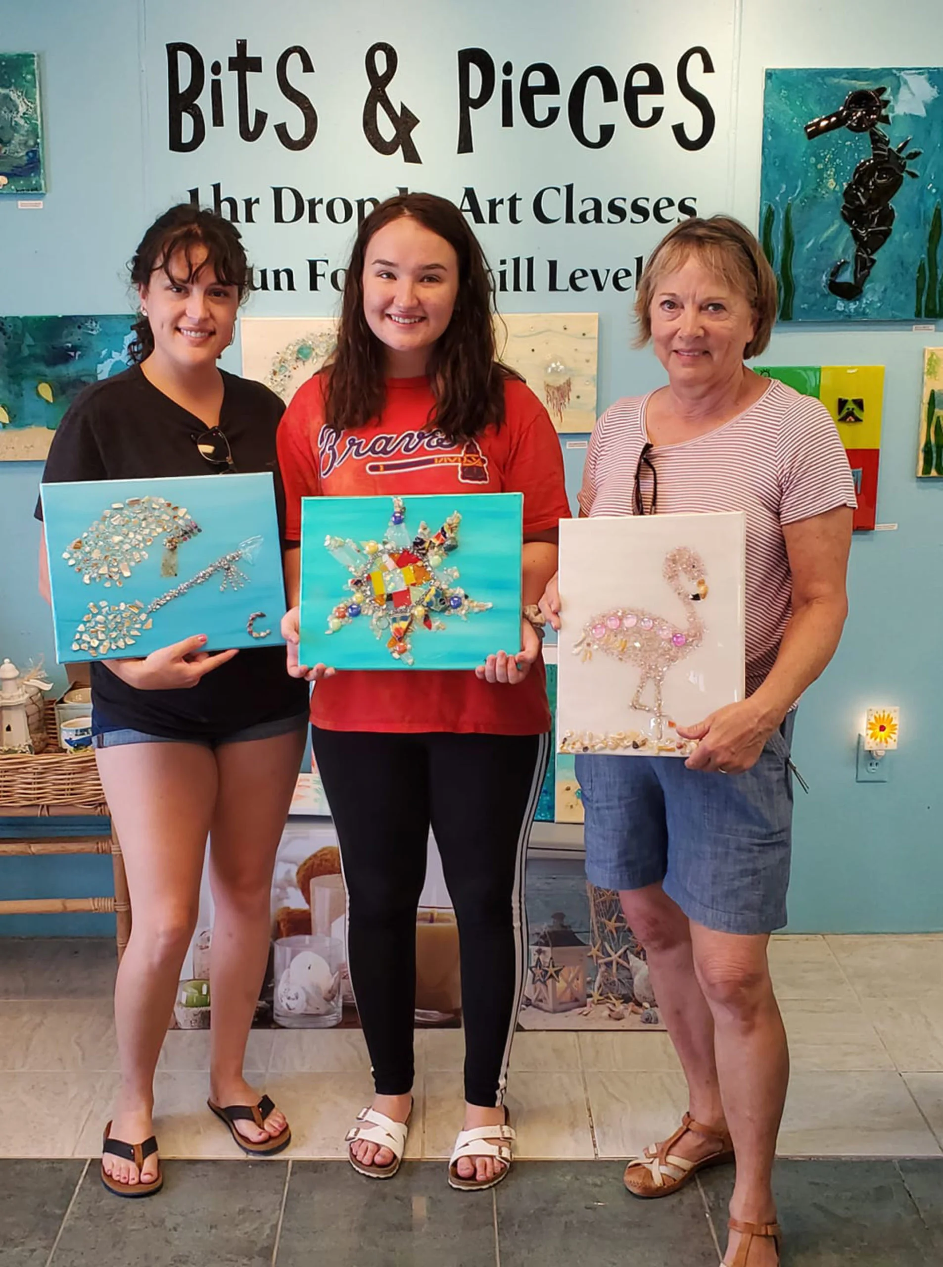 Three ladies showing off work at Art of Glass SGI